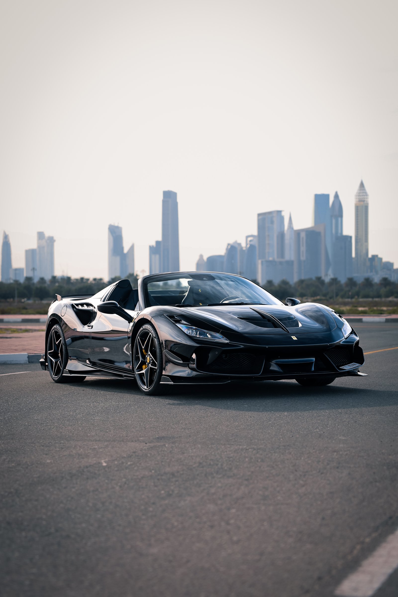 Ferrari F8 Tributo Spider black Dubai skyline view