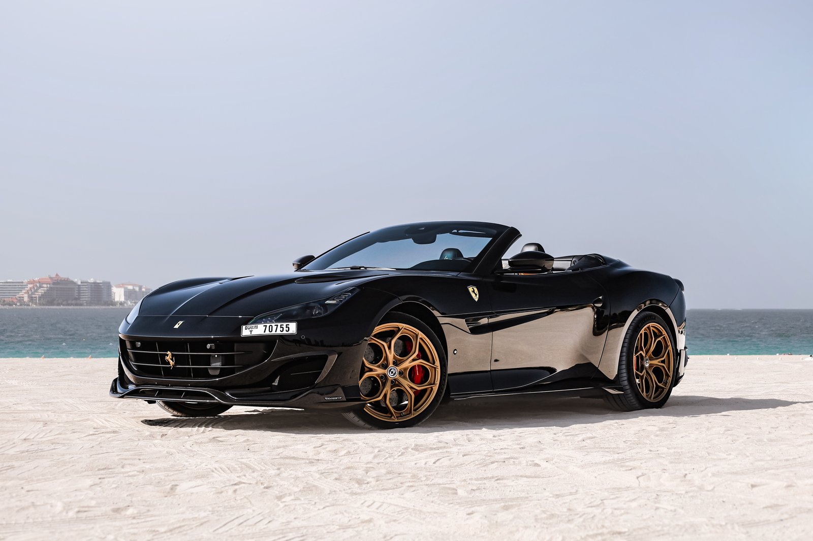 Ferrari Portofino Mansory black front three-quarter view at beach