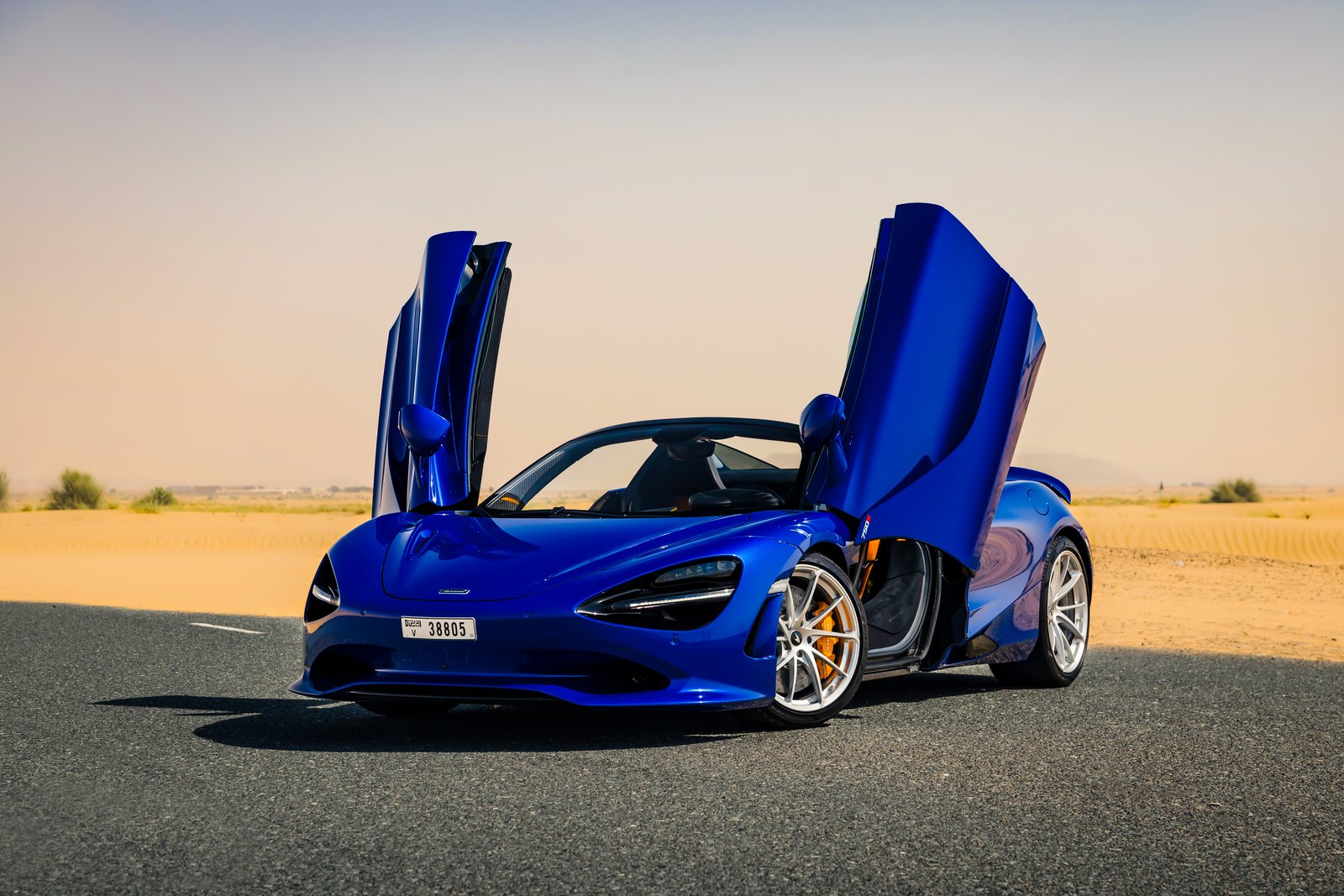 McLaren 750S Spider blue front view doors up