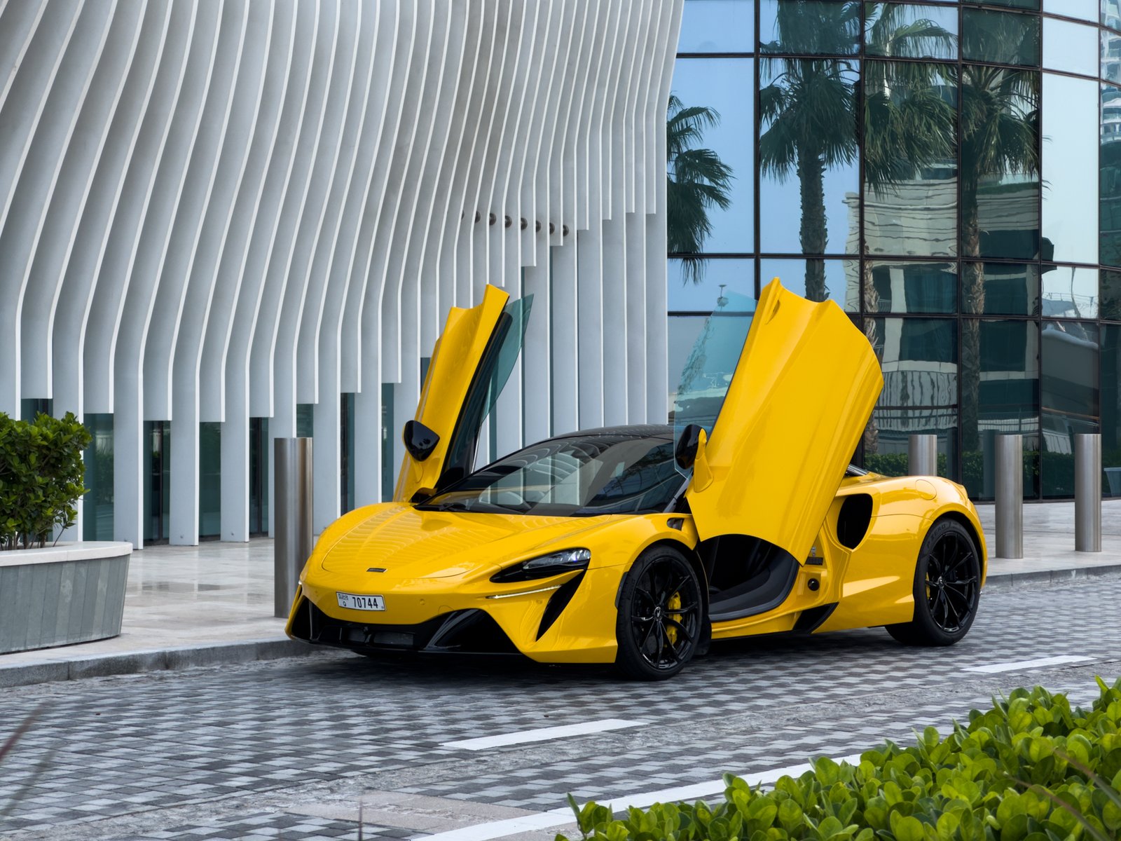 McLaren Artura yellow front view doors up