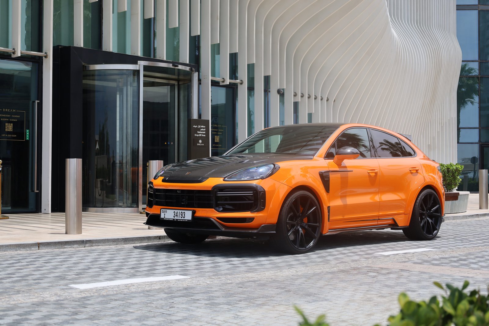 Porsche Cayenne Mansory orange front three-quarter view